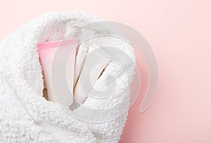 Femine body shaving set covered in towel on pink photo
