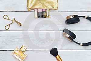 Feminine accessories gold: Lip gloss, perfume, headphones on Woo
