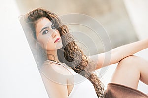 Feminine beauty. Curly-haired young woman model.