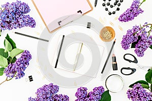 Feminine composition with clipboard, diary, lipstick, lilac flowers and accessories on white background. Flat lay, top view