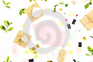 Feminine composition with flowers, pink envelope, cosmetics and gifts on white background