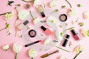 Feminine cosmetics and white flowers on pink background. Flat lay, top view. Beauty concept for woman