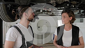 Feminine customer on automobile station, Professional maintenance people concept, car`s service worker Advised client