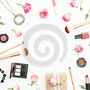 Feminine desk with gift box, pink roses, cosmetics, diary on white background. Top view. Flat lay. Valentines day frame compositio