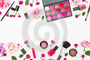 Feminine desk with woman cosmetic and pink roses on white background. Flat lay, top view. Beauty border frame for woman