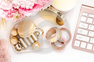 Feminine desktop with gold and pink stationery including a keyboard and mouse