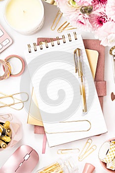 Feminine desktop with gold and pink stationery including a keyboard and mouse