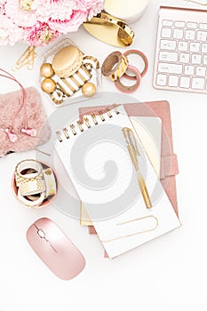 Feminine desktop with gold and pink stationery including a keyboard and mouse