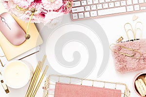 Feminine desktop with gold and pink stationery including a keyboard and mouse