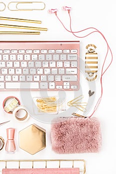 Feminine desktop with gold and pink stationery including a keyboard and mouse