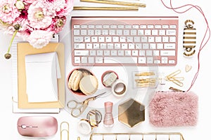 Feminine desktop with gold and pink stationery including a keyboard and mouse