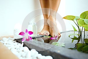 feminine feet by a sunken foot bath