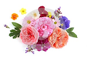 Feminine floral composition. Bouquet of edible wild and garden flowers and herbs. Old roses, sage, pansy, daisy, mallow