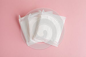 Feminine hygiene and protection, sanitary pads on pastel pink background, top view, flat layout