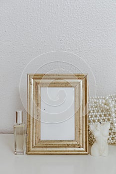 Feminine Mockup vintage gold frame and candle. Wedding still life.