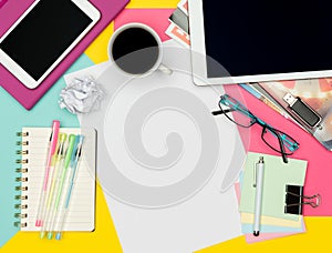 Feminine Office Desk Working Space Flat Lay. Top view photo of workspace with blank sheet of paper mock up and fashion magazines.