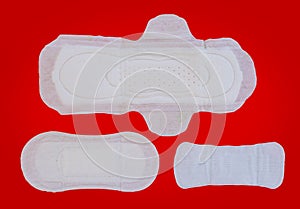 Feminine sanitary napkin on red background