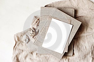 Feminine stationery, desktop mock-up scene. Blank greeting card, craft envelope, sea shells and old books on beige linen