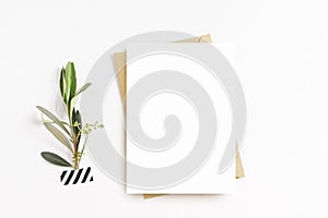 Feminine stationery, desktop mock-up scene. Blank greeting card, craft envelope, washi tape and with olive branch.White