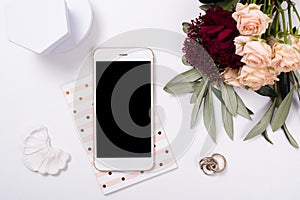 feminine tabletop flatlay with smartphone mock-up