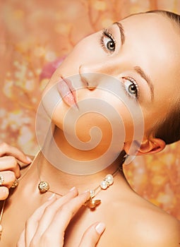 Feminine. Tenderness. Portrait of Imposing Woman with Gold Pearly Chainlet