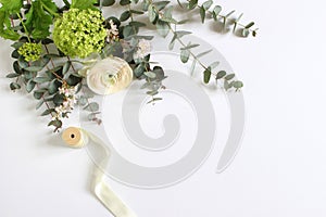 Feminine wedding, birthday desktop mock-up scene. Blank paper greeting card and bouquet of eucalyptus branches, pink