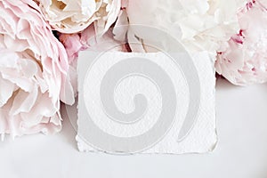 Feminine wedding, birthday mockup scene. Closeup of blank cotton paper card, invitation on pink floral petals and table