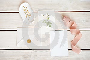 Feminine wedding desktop mock-up with blank paper card and Eucalyptus populus branch on white shabby table background