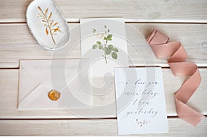 Feminine wedding desktop mock-up with blank paper card and Eucalyptus populus branch on white shabby table background. Empty space