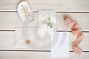 Feminine wedding desktop mock-up with blank paper card and Eucalyptus populus branch on white shabby table background