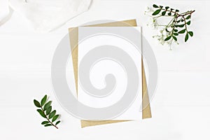 Feminine wedding stationery, desktop mock-up scene. Blank greeting card, craft envelope, baby`s breath flowers, silk