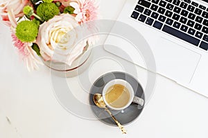 Feminine workplace concept in flat lay style with laptop, coffee