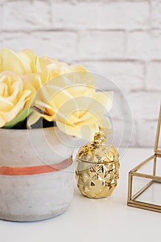 Feminine workplace concept. Freelance fashion comfortable femininity workspace with flowers and golden pineapple on white backgrou