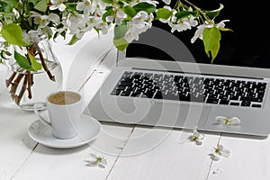 Feminine workplace concept. Freelance fashion comfortable femininity workspace  with laptop, coffee, flowers on white background