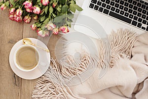 Feminine workplace concept. Freelance workspace with laptop, flowers roses. Blogger working. photo