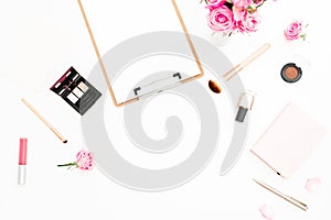 Feminine workspace with pink roses bouquet, cosmetics, diary and clipboard on white background. Top view. Flat lay. Beauty blog, c