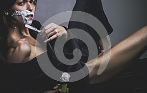 Feminism. Sexy woman shaving and feminism concept. Dominancy of women over men. Matriarchy.