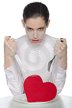 Femme fatale threatening heart on a plate photo