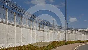 Fence along a street with barbed wire around the harbor of calais