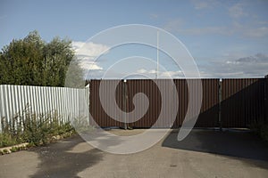 Fence around wasteland. Steel fence around abandoned area. Directions in industrial zone