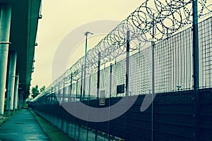 A fence with barbed wire - a concept of prison, imprisonment