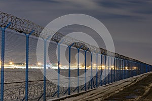 Fence with barbed wire, restricted area and starting plane