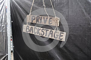 Fence with black plastic sheet with a board privat backstage