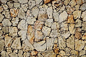 Fence of caliche stone pattern. Rock texture photo