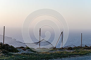 Fence on coast line of sea shore in Malta island