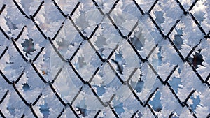 Fence covered with hoarfrost on a frosty winter day