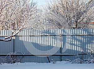 A fence is covered in snow