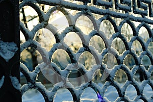 fence covered snow winter park