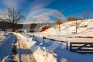 Fence and farm field along a snow-covered road in Seven Valleys, Pennsylvania.