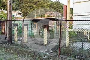 Fence in front of abandoned security building for an industrial factory